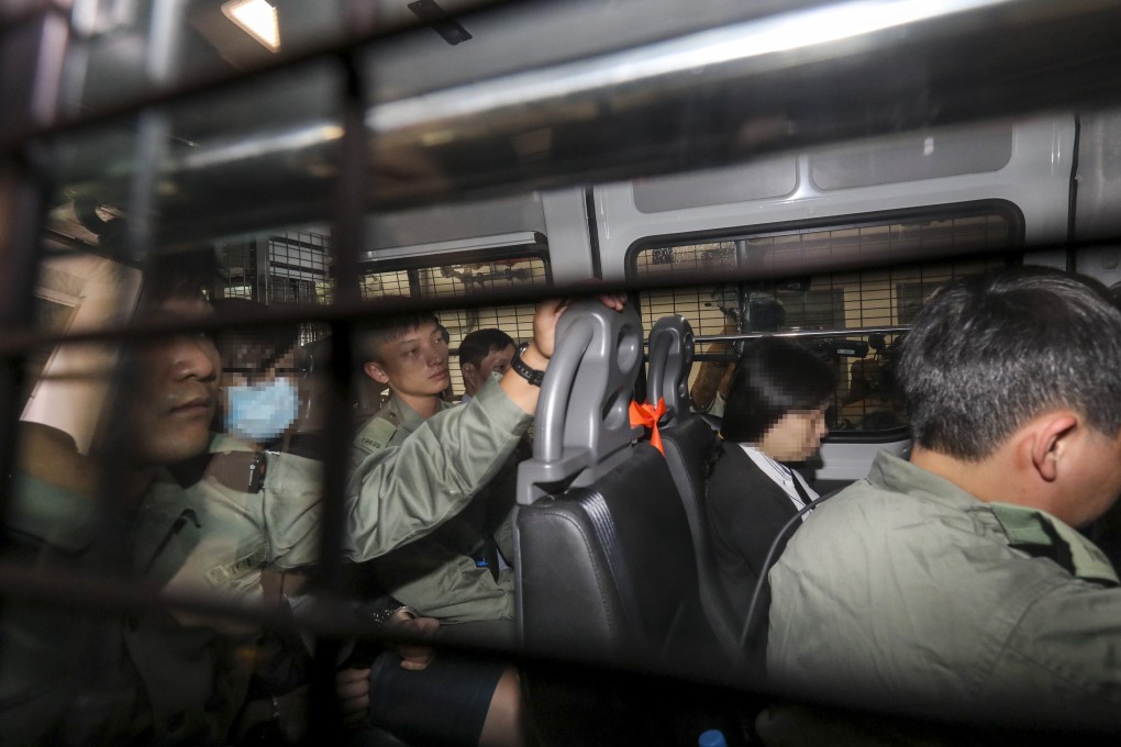 Ng Lung-ping, seen in a mask on the left, and Choi Yuk-wan (second from right) on their way to Eastern Court where they were accused of wearing masks during a public assembly. Photo: May Tse