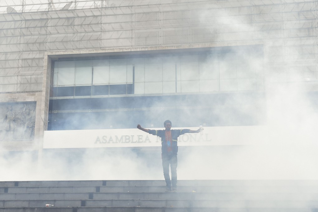 Anti-government protesters briefly stormed the Ecuadorean parliament in Quito before being driven out by police. Photo: AFP