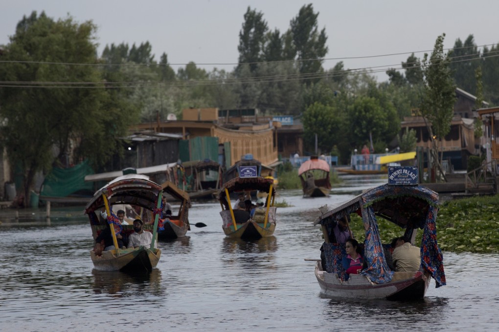 Tourists in shikaras, traditional gondolas, cross the Dal Lake in Indian-controlled Kashmir. Photo: AP