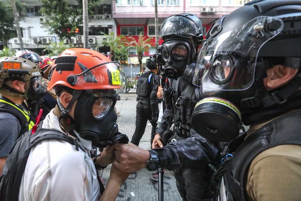 Reporters can have their gas masks removed by police under the new law. Photo: Felix Wong