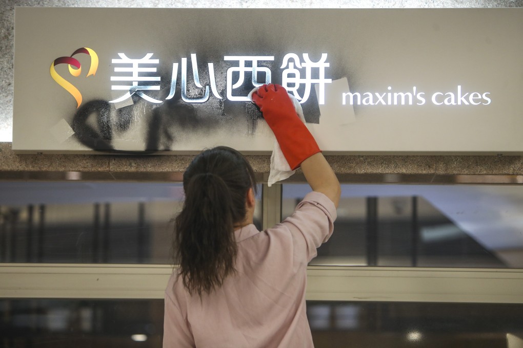 A worker cleans up after vandalism at a Maxim’s cake shop in New Town Plaza, Sha Tin. Photo: Winson Wong