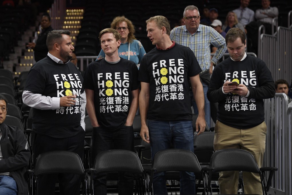 Activists wear “Free Hong Kong” T-shirts before an NBA exhibition game between the Washington Wizards and the Guangzhou Loong-Lions on October 9 in Washington. Photo: AP