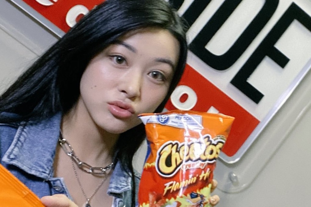 Emily Mei poses with a bag of Flamin’ Hot Cheetos in a photo posted on Twitter on Thursday. Photo: Emily Mei via Twitter