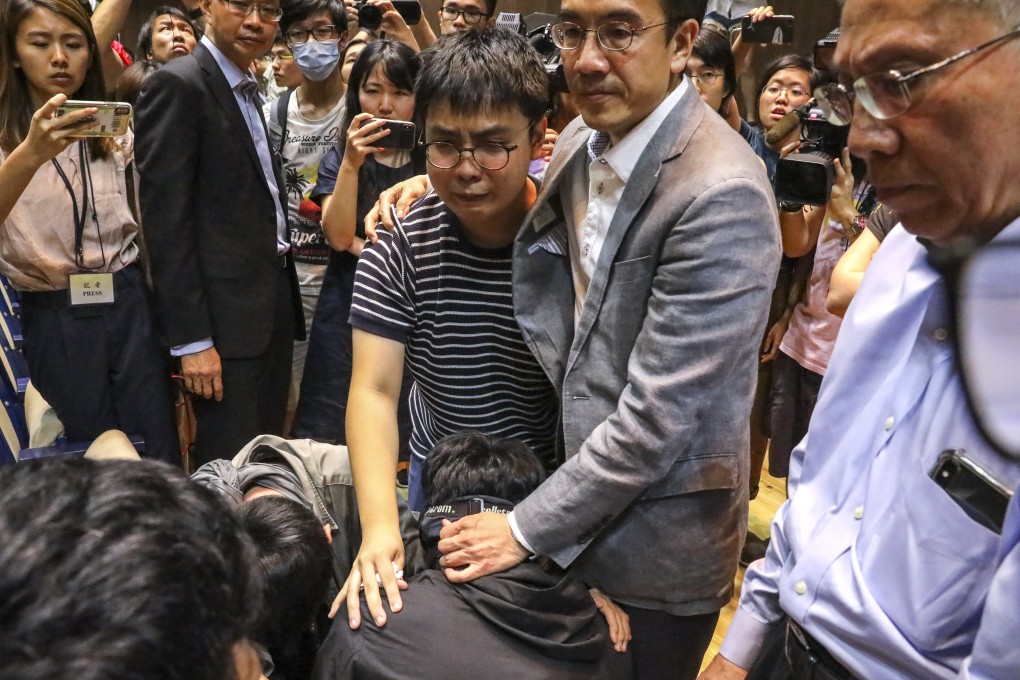 Chinese University pro-vice-chancellor Dennis Ng comforts students as they get emotional after a meeting with the school’s president. Photo: K.Y. Cheng