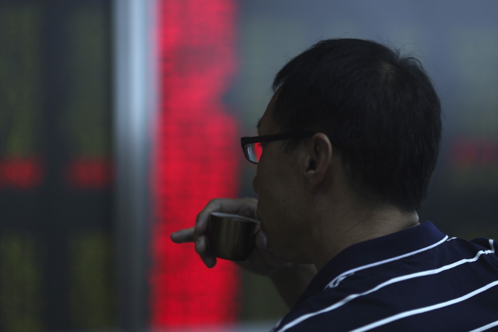 An investor monitors stock prices at a brokerage in Beijing. China appears to have accelerated its efforts to open up its financial sector amid its trade spat with Washington. Photo: AP