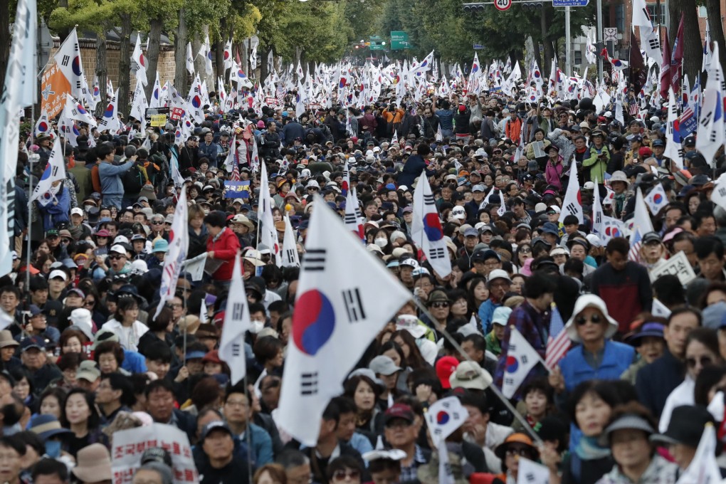 Demonstrators march near Seoul’s presidential Blue House on Wednesday in protest at the appointment of Cho Kuk. Photo: AP