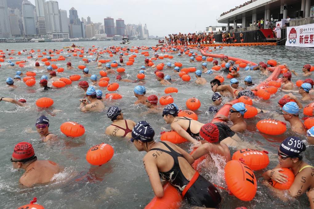 Swimmers from all categories take to Victoria Harbour from Tsim Sha Tsui Public Pier to Wan Chai Golden Bauhinia Square Public Pier during the New World Harbour Race 2018. Photo: Robert Ng