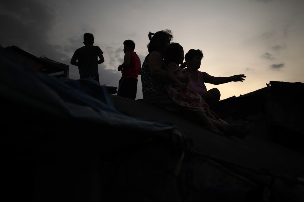 Filipino children on the roof of a dilapidated government housing project in Manila. Photo: EPA-EFE