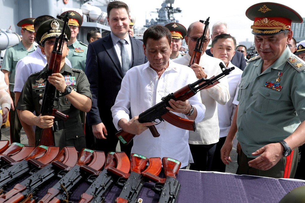 Philippine President Rodrigo Duterte holds an AK-47 assault rifle on board the Russian destroyer Admiral Panteleyev in 2017. Photo: Reuters
