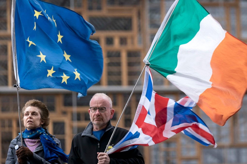Anti-Brexit activists hold the flags of the EU, Britain and Ireland in Brussels. Photo: AFP