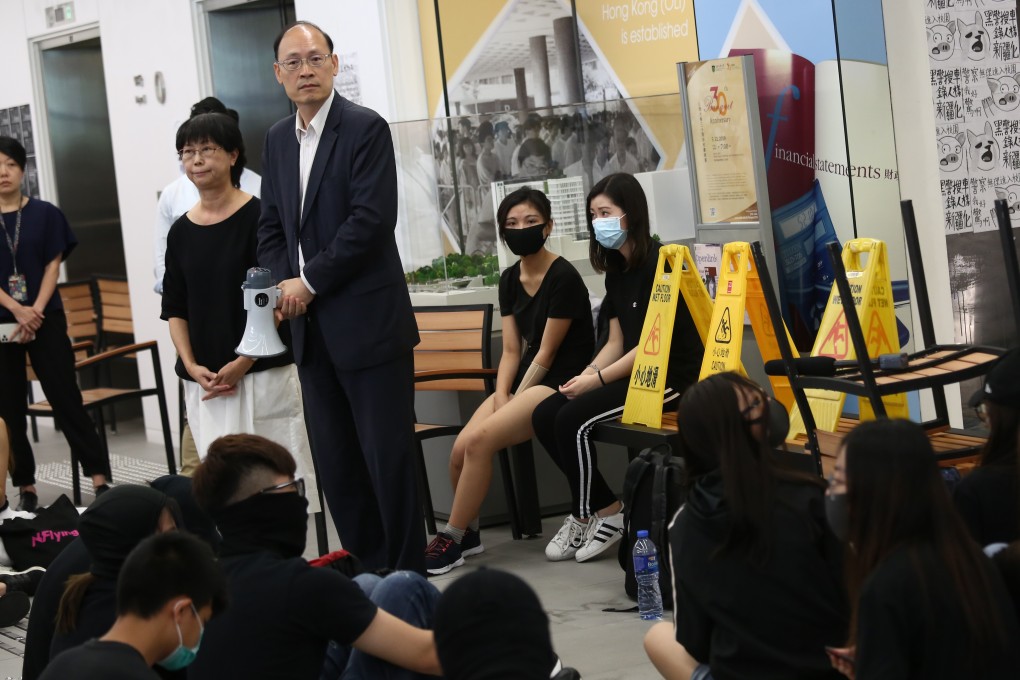 Dorinda Chan (left), the director of student affairs at the Open University, and Professor Tong Chong-sze, the vice president of administration and development, speak to student protesters on Friday. Photo: Jonathan Wong