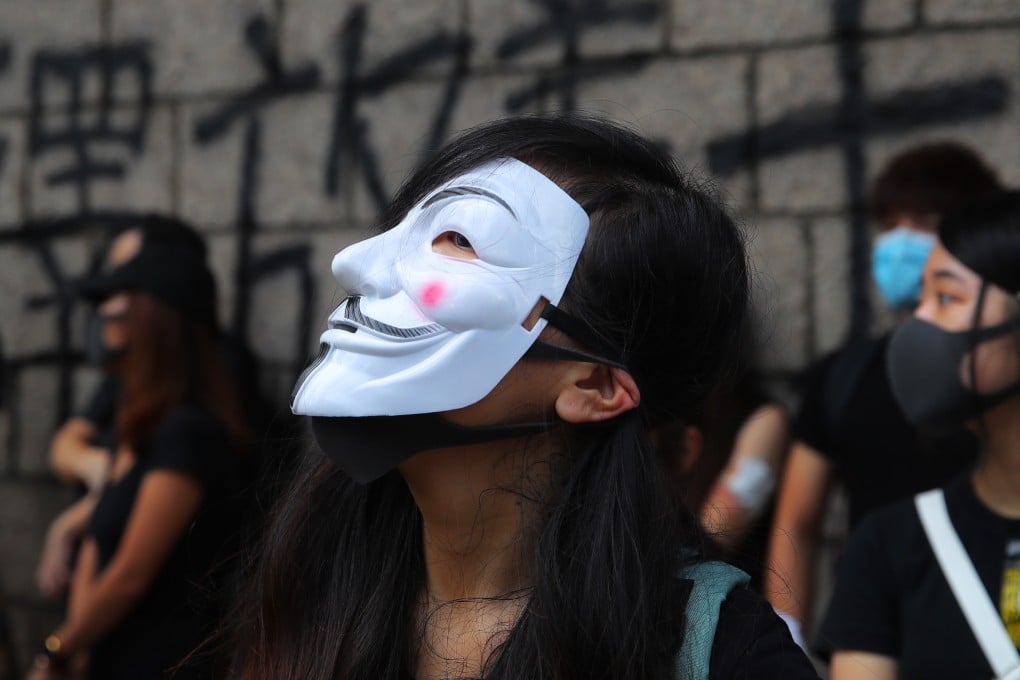 A woman in a Guy Fawkes mask and other masked protesters gather outside the High Court on October 9, during an appeal hearing for pro-independence activist Edward Leung. Until the violence broke out, Hong Kong was widely admired as a beacon of civilised freedom and rule of law. Today’s vivid image is a city controlled by gas-masked black shirts. Photo: EPA-EFE