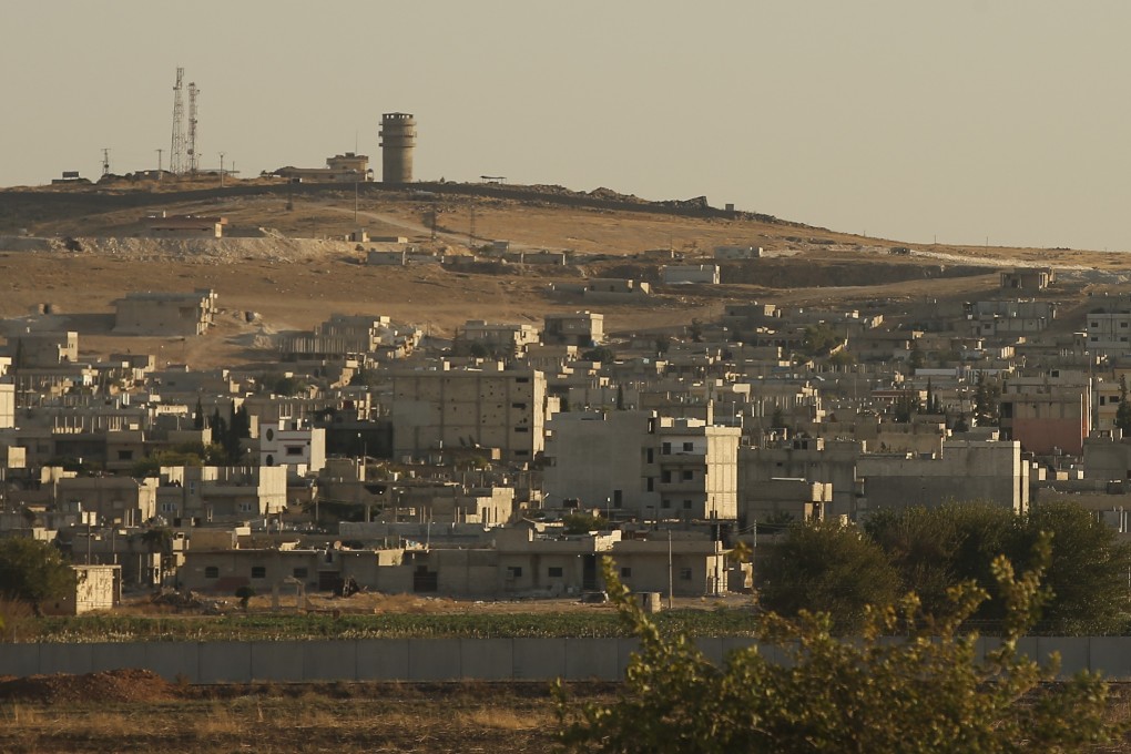 A US forces outpost is seen on a hilltop, top left, outside Ayn Al Arab or Kobani, Syria. Photo: AP Photo