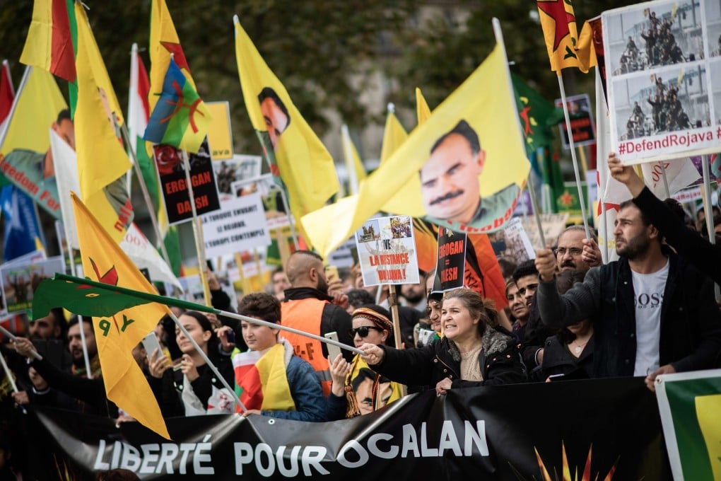 People hold pro-Kurd flags and banner in Paris on October 12. Photo: AFP