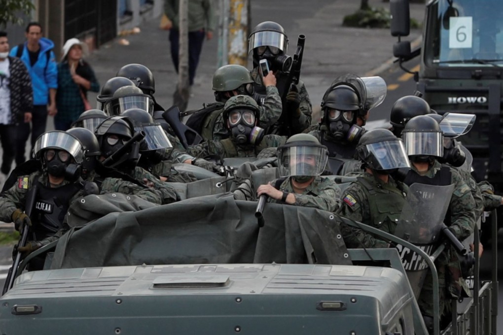 Ecuadorean troops move through the streets of Quito after the curfew started. Photo: EPA