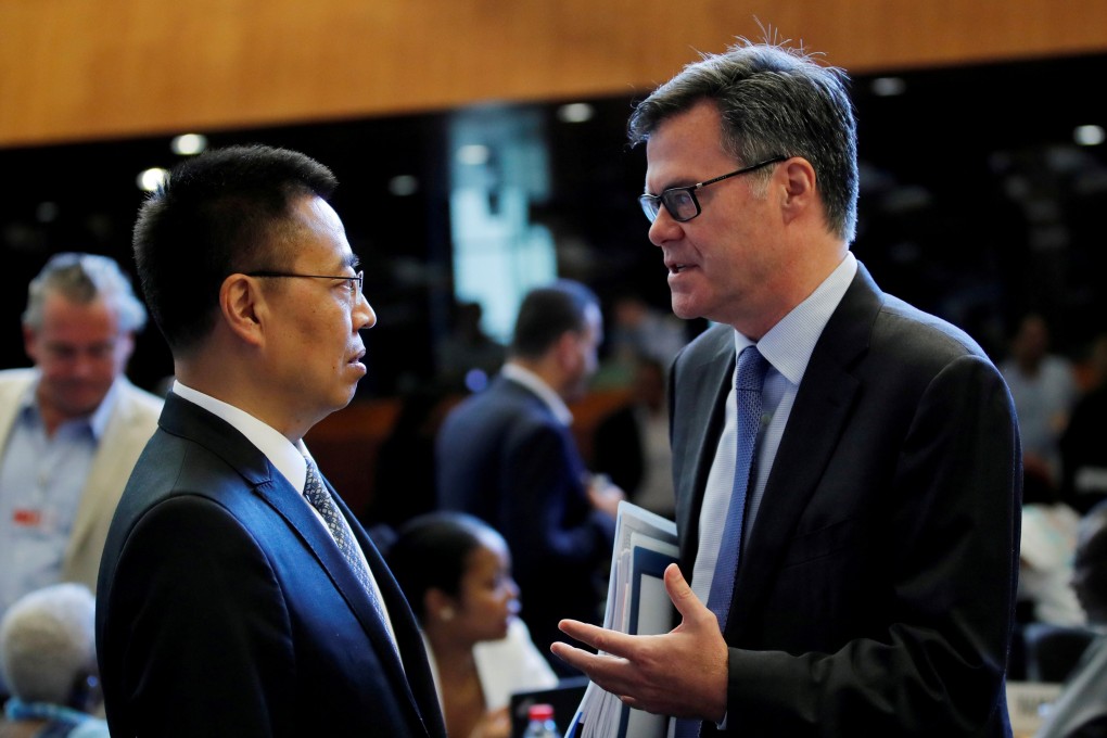 Zhang Xiangchen, Chinese ambassador to the WTO, talks to his US counterpart, Dennis Shea, before a General Council meeting in 2018. Photo: Reuters
