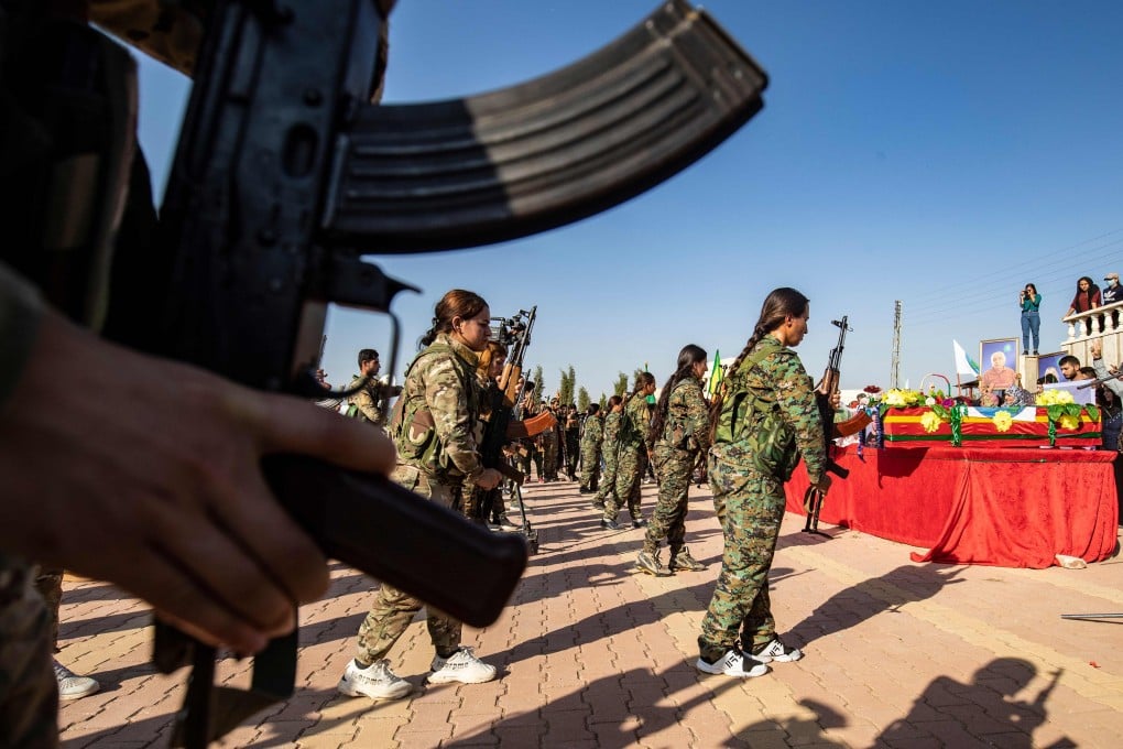 Mourners attend a funeral for Kurdish political leader Hevrin Khalaf and others including civilians and Kurdish fighters, in the northeastern Syrian Kurdish town of Derik. Photo: AFP