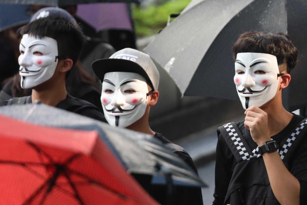 Protesters march with their masks on. Photo: Xiaomei Chen