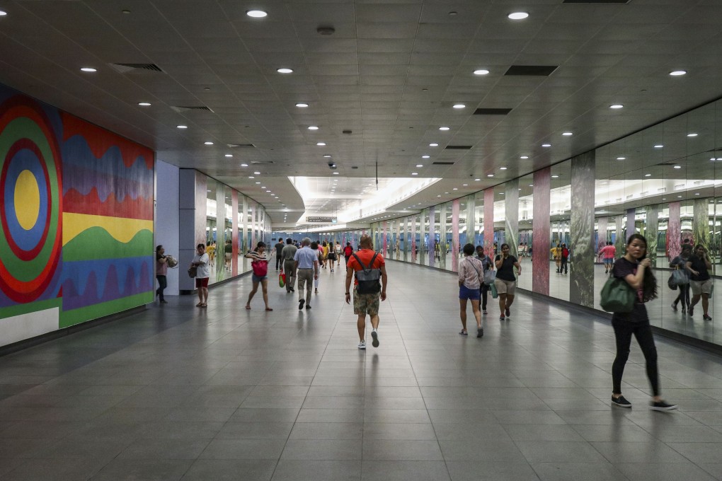 Commuters walk through an MRT station linked to the Marina Bay Sands resort in Singapore. Photo: Roy Issa