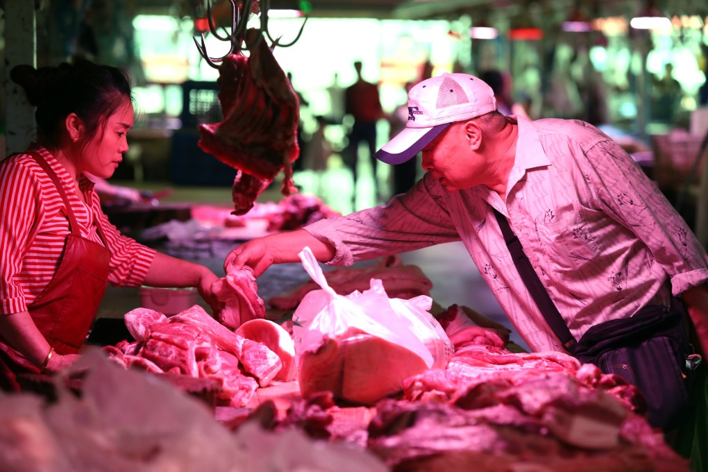 A customer buys pork at a wholesale market in Beijing. Rising pork prices pushed up inflation on the mainland last month. Photo: Simon Song