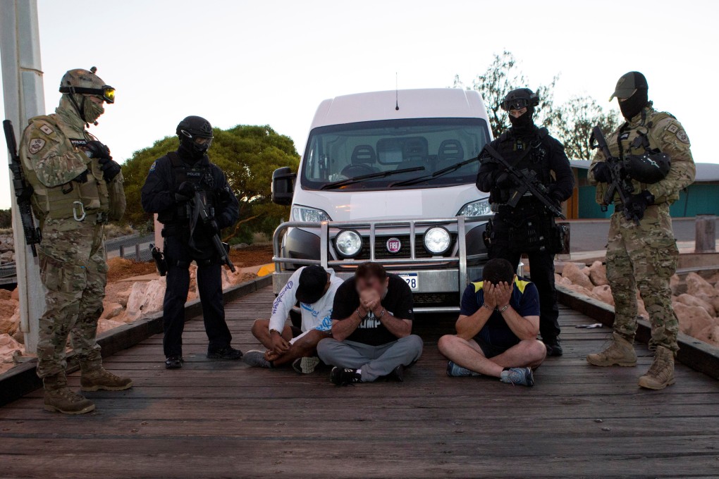 Police officers stand around suspects arrested during an operation that, according to police, resulted in the seizure of 1.2 tonnes of methamphetamine in Geraldton, Australia in 2017. File photo: Reuters