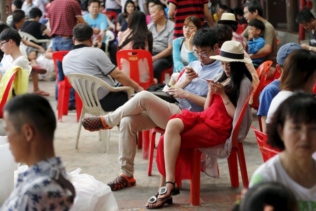 Chinese tourists wait for a boat at a pier at Chao Phraya River in Bangkok. Photo: Reuters