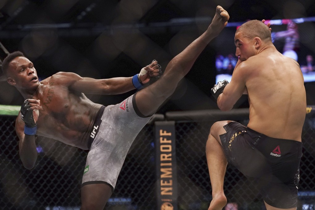 Israel Adesanya kicks Robert Whittaker at UFC 243. Photo: AP