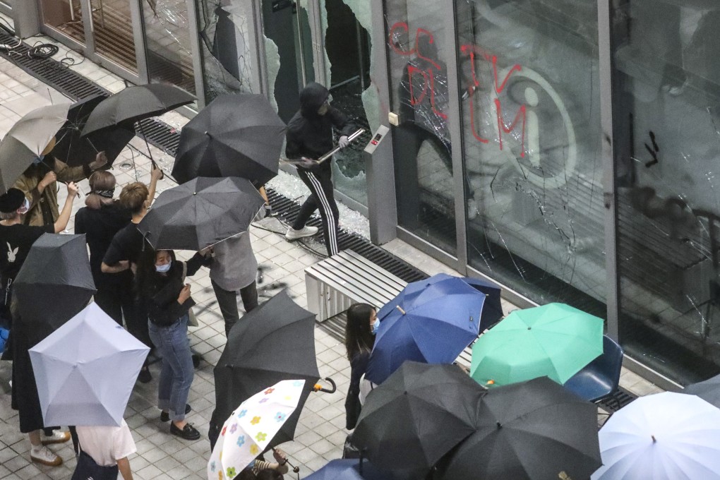 Students smash glass doors at the Hong Kong Design Institute on Monday. Photo: Dickson Lee
