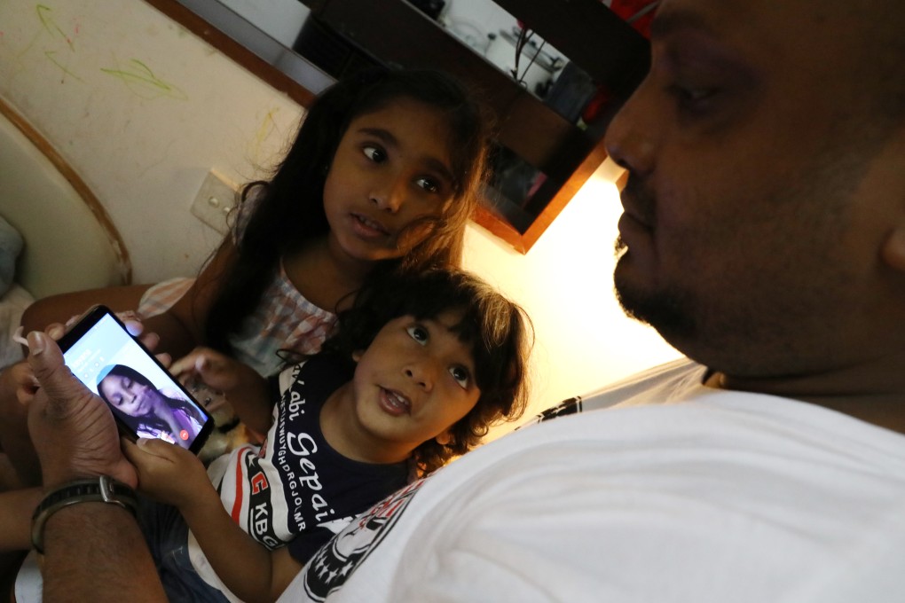 Sethumdi, 7, and her brother Dinath, 3, who are in Hong Kong, make a video call to Rodel, who is in Canada, on Kellapatha’s mobile phone. Photo: Nora Tam
