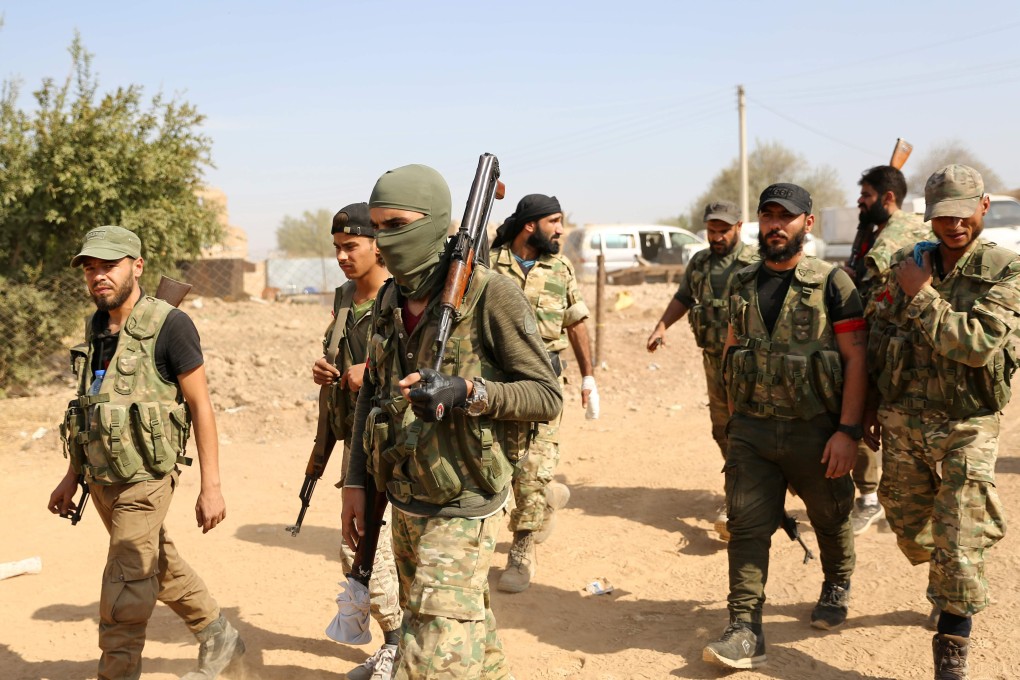 Turkey-backed fighters at the Syrian border town of Ras al-Ain. Photo: AFP