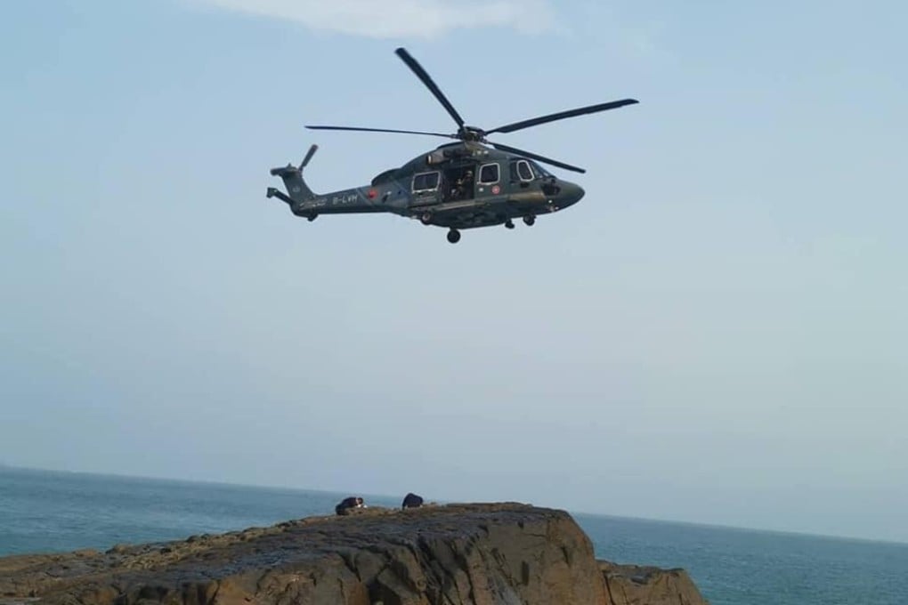 A rock climber is lifted to safety after he was hit by a rock on Tung Lung Island. Climbers think a hiker threw it, unaware people were below. Photos: Handout