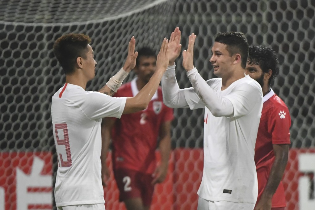 Wei Shihao (left) celebrates a China victory with Elkeson. Photo: Xinhua