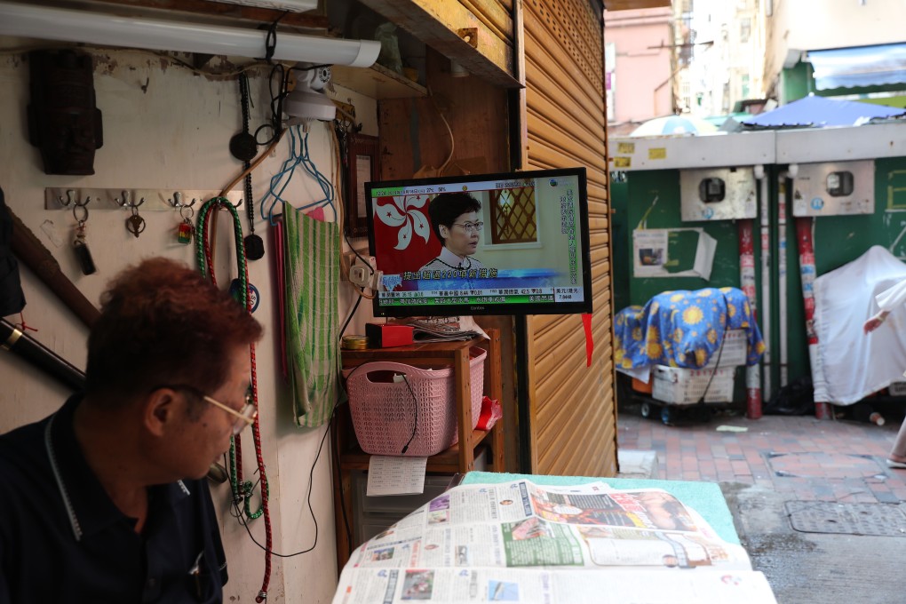 A Hongkonger tunes into Carrie Lam’s policy address on Wednesday, which promised to tackle residents’ housing grievances. Photo: Sam Tsang