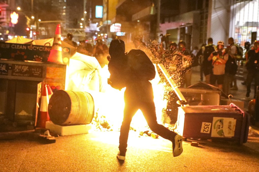 Protesters throw petrol bombs and set objects on fire during a scuffle with police on September 29. Photo: K.Y. Cheng