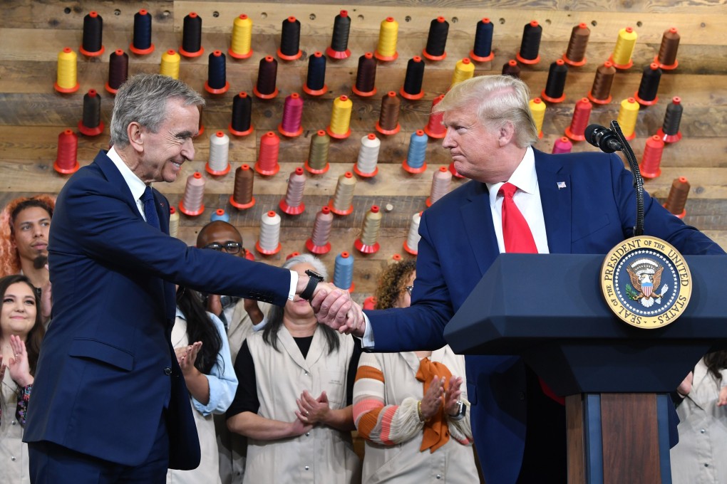 US President Donald Trump shakes hands with chief executive of LVMH Bernard Arnault at the opening of the new Louis Vuitton factory in Alvarado, Texas. Its inauguration makes good on a pledge by Arnault to Trump to create jobs in the United States. Photo: AFP