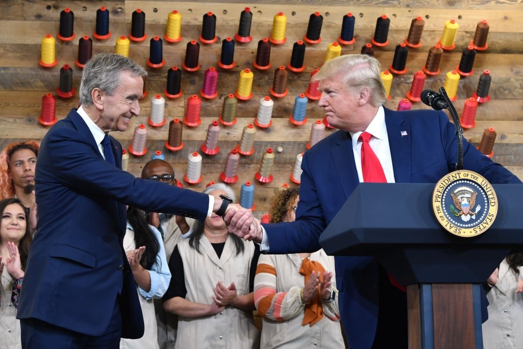 US President Donald Trump shakes hands with chief executive of LVMH Bernard Arnault at the opening of the new Louis Vuitton factory in Alvarado, Texas. Its inauguration makes good on a pledge by Arnault to Trump to create jobs in the United States. Photo: AFP