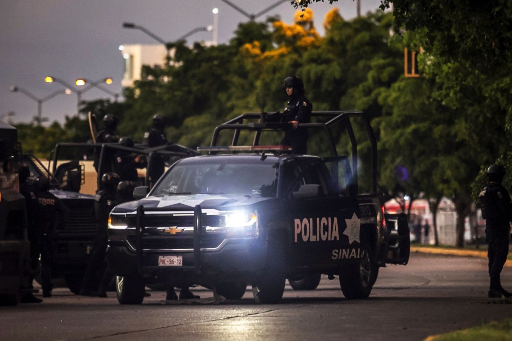 Mexican police patrol in a street of Culiacan in Sinaloa. Photo: AFP