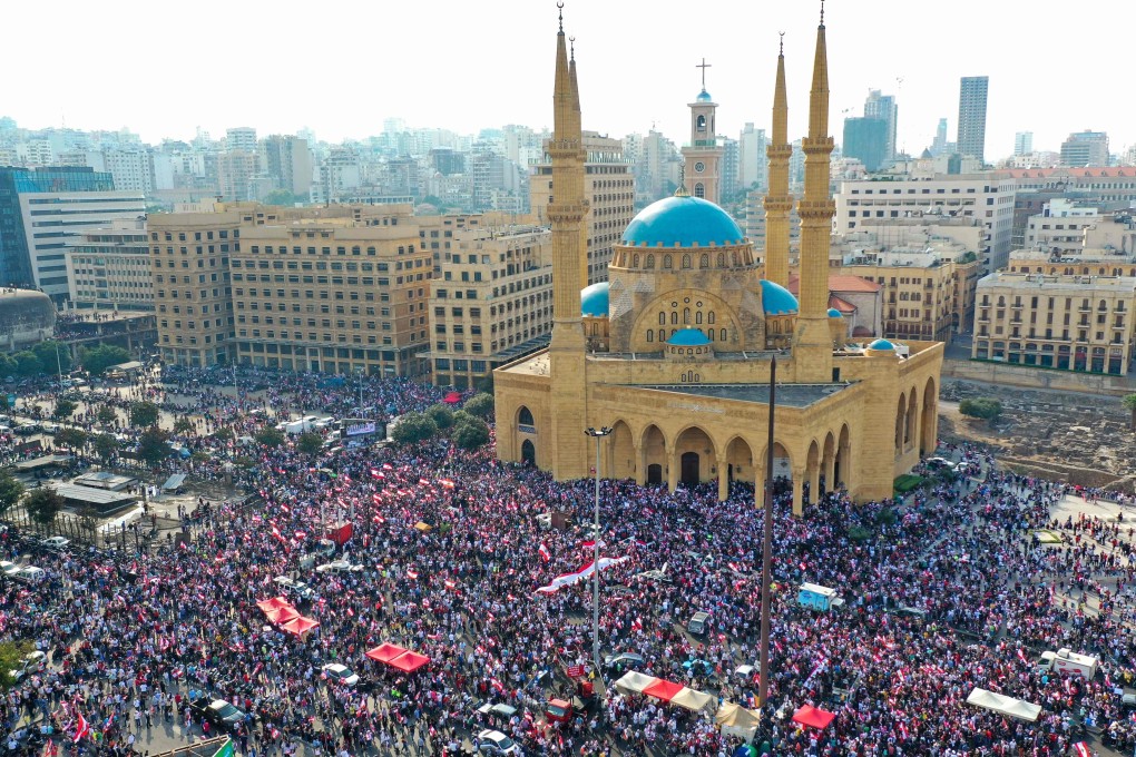 Lebanese protesters converge on downtown Beirut for a fourth day of demonstrations against tax increases and official corruption. Photo: AFP