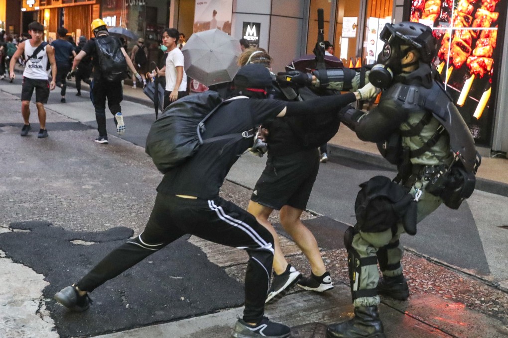 Riot police make arrests after scuffles with anti-government protesters during a rally in defiance of the anti-mask law on October 6. Photo: Sam Tsang