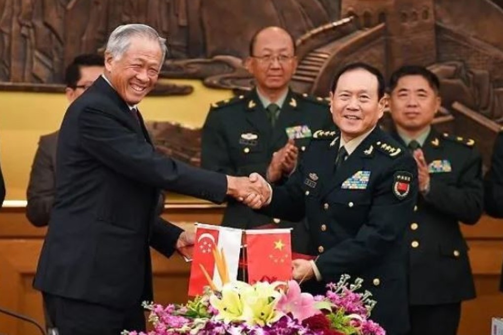 Singapore's Defence Minister Ng Eng Hen (L) and China’s Defence Minister Wei Fenghe (R) shake hands at the signing of the updated defence agreement. Photo: Mindef