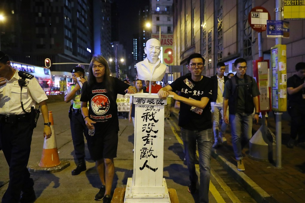 Pro-democracy activists Leung Kwok-hung (left) and Avery Ng Man-yuen march with a statue of Liu Xiaobo on June 4, when Hongkongers hold an annual candlelight vigil to commemorate the 1989 Tiananmen Square crackdown. Liu famously said: “I have no enemies and no hatred.” Photo: Edmond So