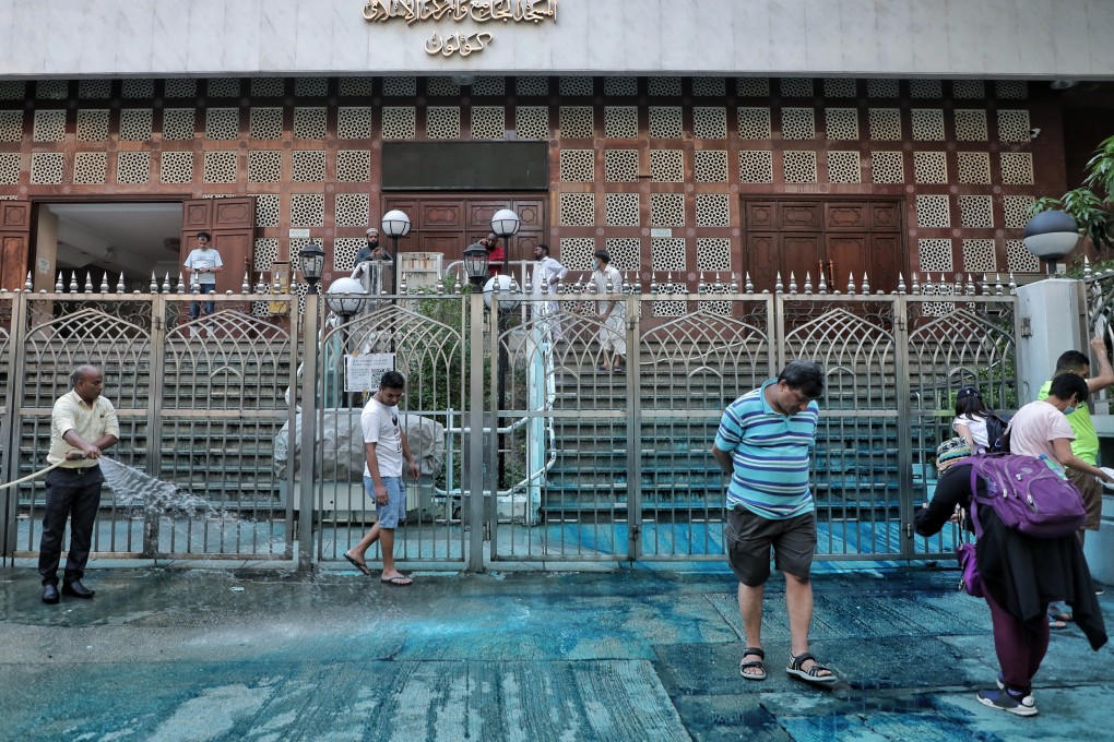 Volunteers help clean up Kowloon Mosque in Tsim Sha Tsui on Sunday after a police water cannon sprayed the building with blue-dyed water. Photo: Handout