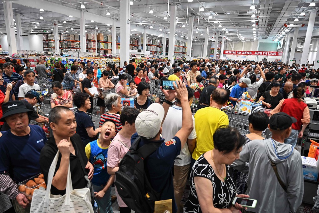 Customers make a beeline at Costco’s store opening in Shanghai on August 27, 2019. Photo: AFP