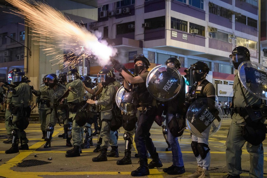 Police fire tear gas on Nathan Road on Sunday night. Photo: AFP