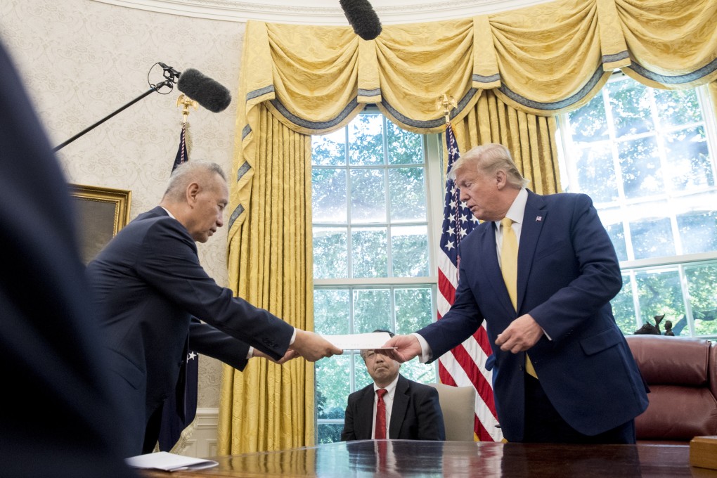 US President Donald Trump receives a letter presented to him by Chinese Vice-Premier Liu He in the Oval Office of the White House on October 11. Photo: AP