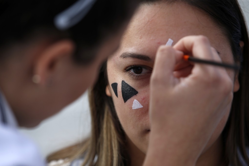 Members of a rights group use paint to confuse the Huawei surveillance video cameras featuring facial recognition software in Belgrade, Serbia, on September 25. With public authorities disclosing little about how the cameras work, the group set up a tent to ask pedestrians whether they knew they were being watched. Photo: AP