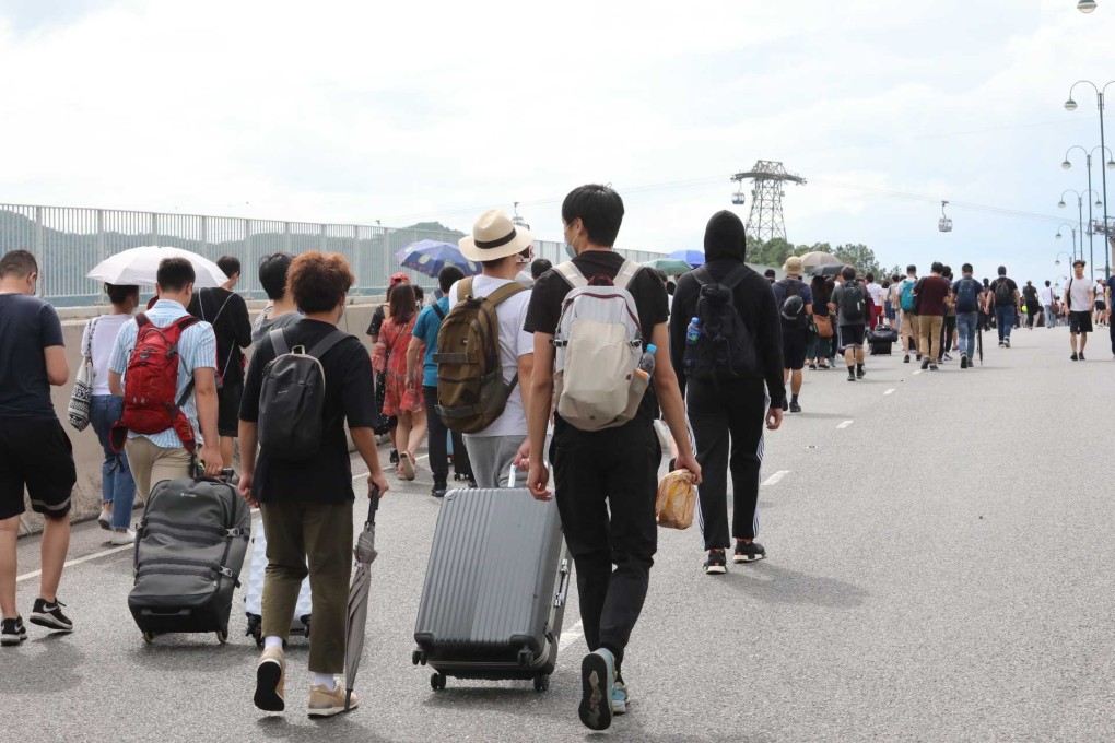 Travellers and airline crew forced to get off their buses at the bridge connecting Tung Chung and Hong Kong International Airport on 1 September 2019, as protesters crippled airport services. Photo: Felix Wong
