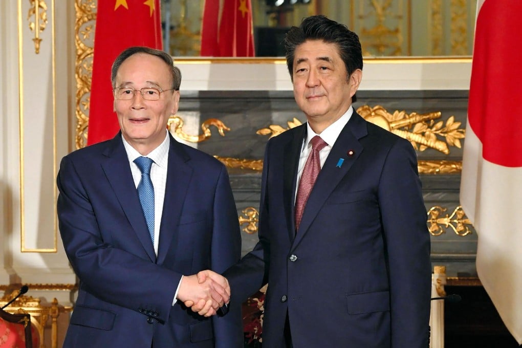 Japan's Prime Minister Shinzo Abe greets Chinese Vice-President Wang Qishan at the Akasaka State Guesthouse in Tokyo. Photo: Jiji Press/ AFP