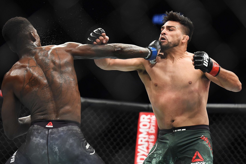 Israel Adesanya punches Kelvin Gastelum at UFC 236. Photo: AFP