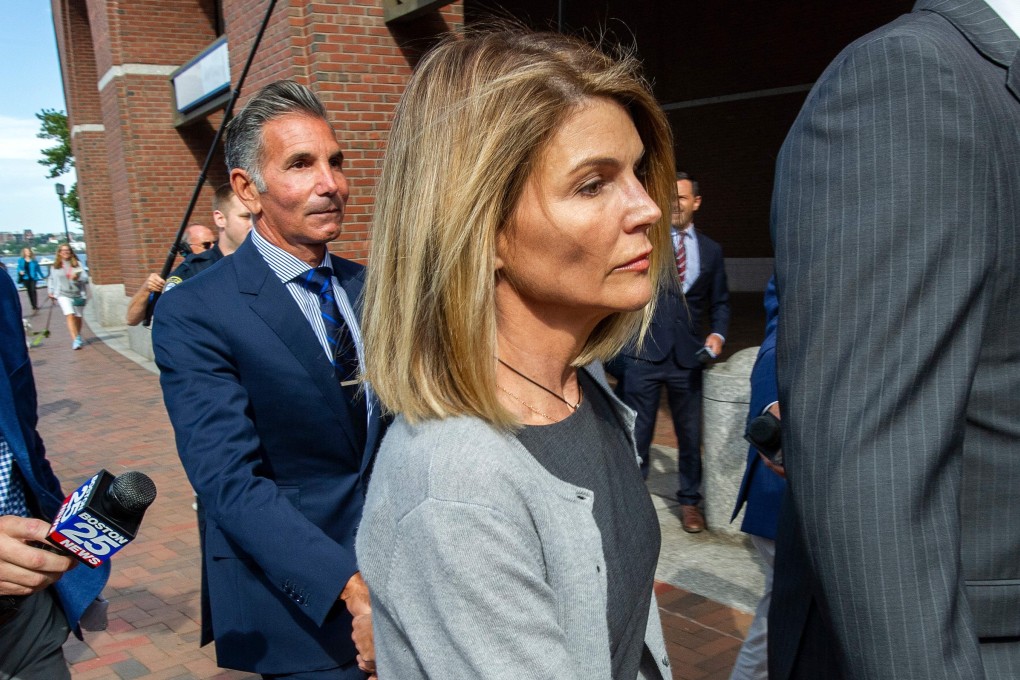 Actress Lori Loughlin and husband, Mossimo Giannulli, exit Boston Federal Court in August. Photo: AFP